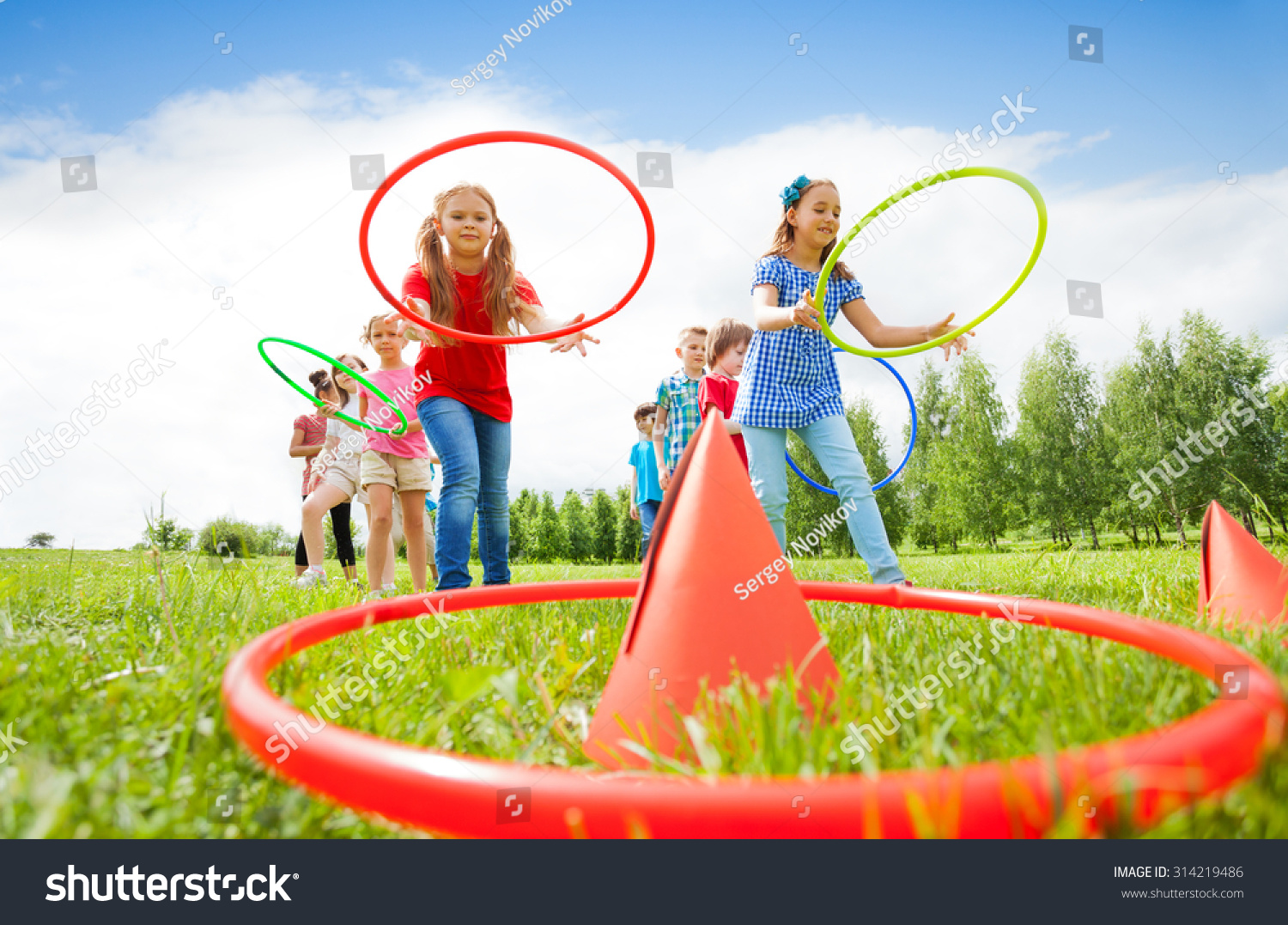 Stock Photo Kids Throw Colorful Hoops On Cones While Competing 314219486